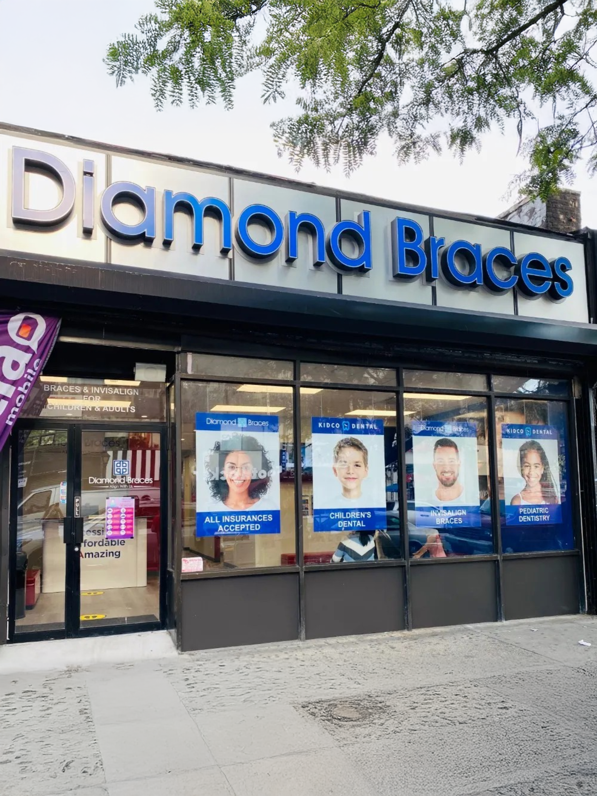 Diamond Braces dental office exterior with large promotional posters for metal braces or Invisalign on windows.