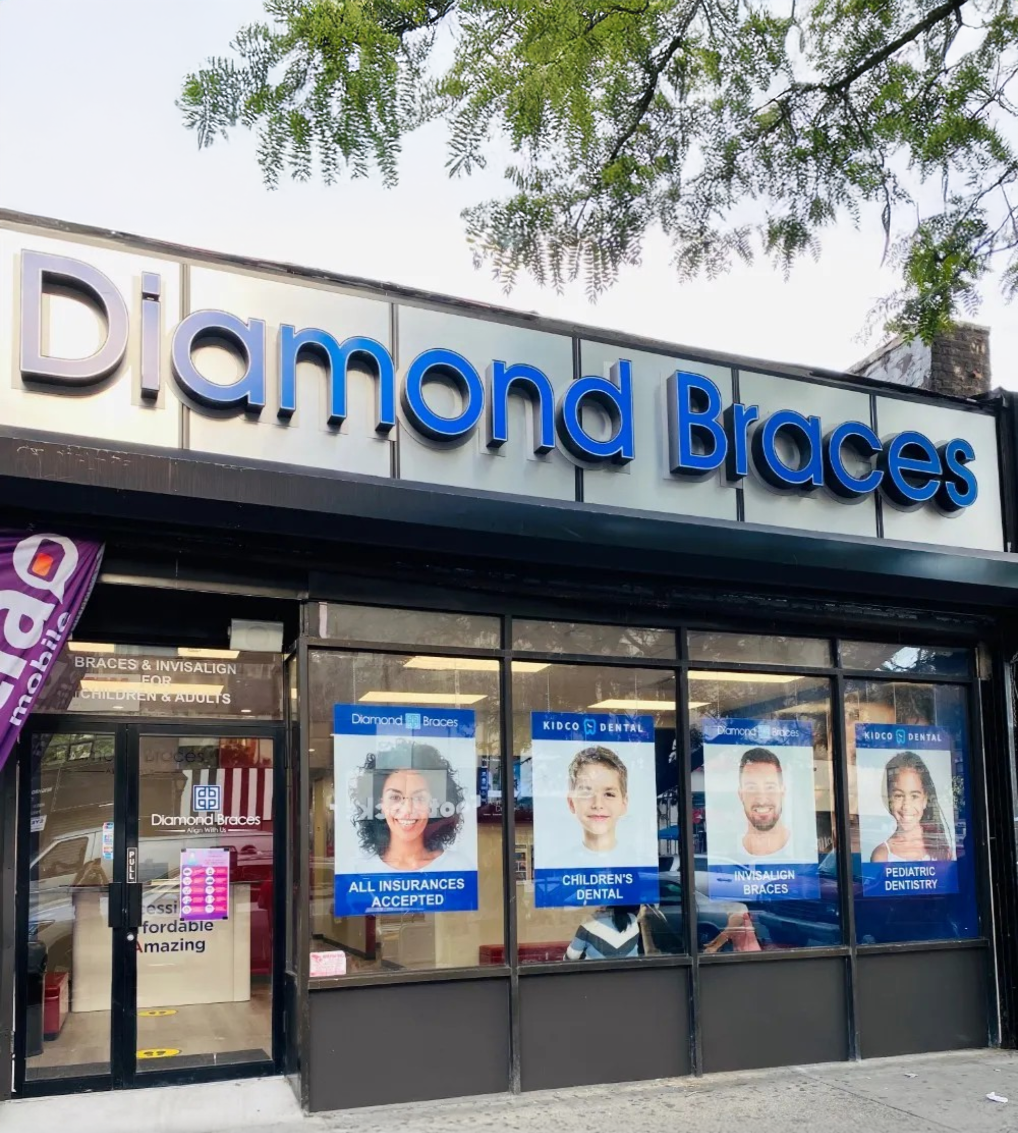 Diamond Braces dental office exterior with large sign and promotional posters on windows.