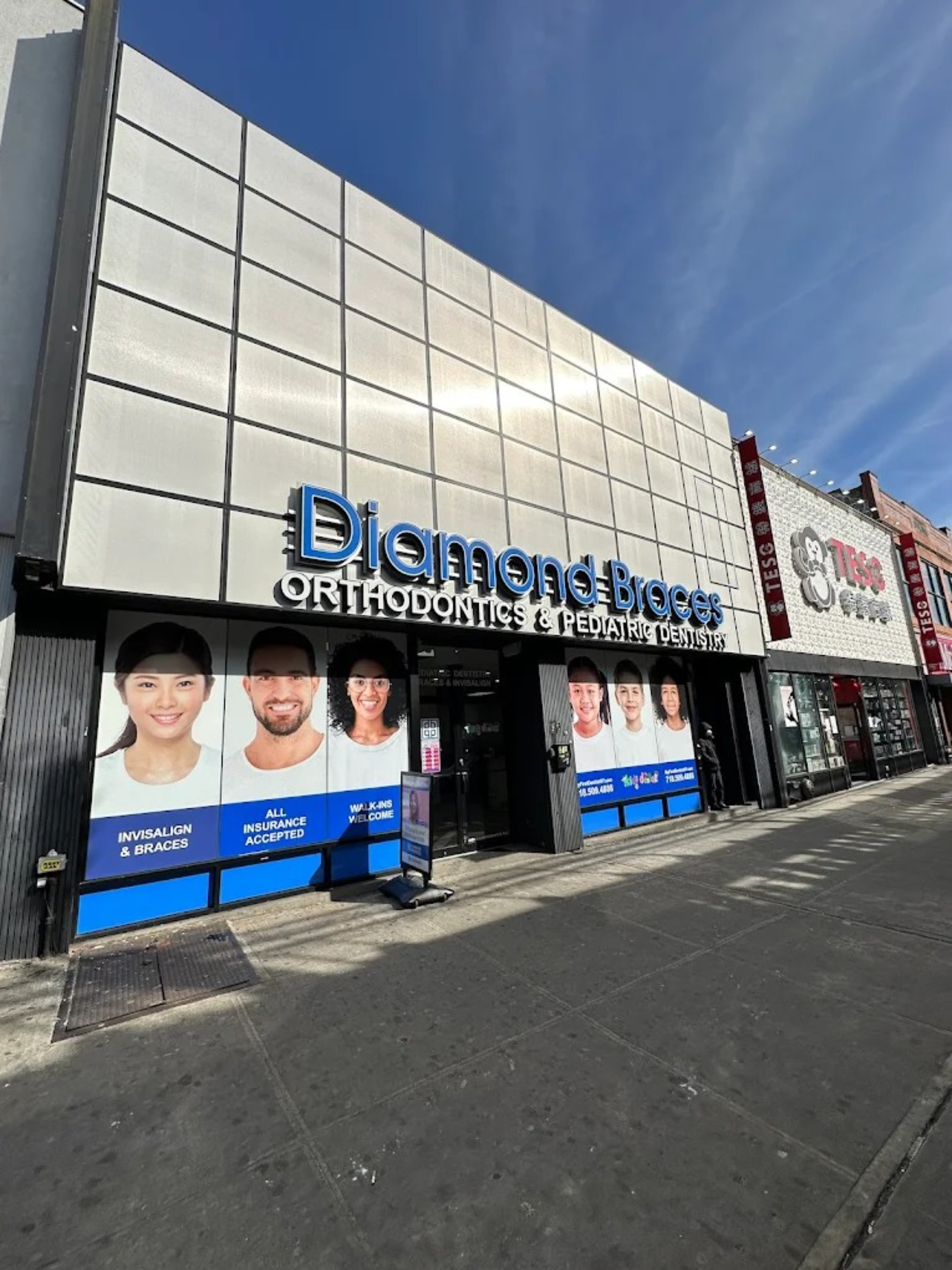 Diamond Braces orthodontics clinic with large sign and promotional posters on a building facade in Downtown Brooklyn.