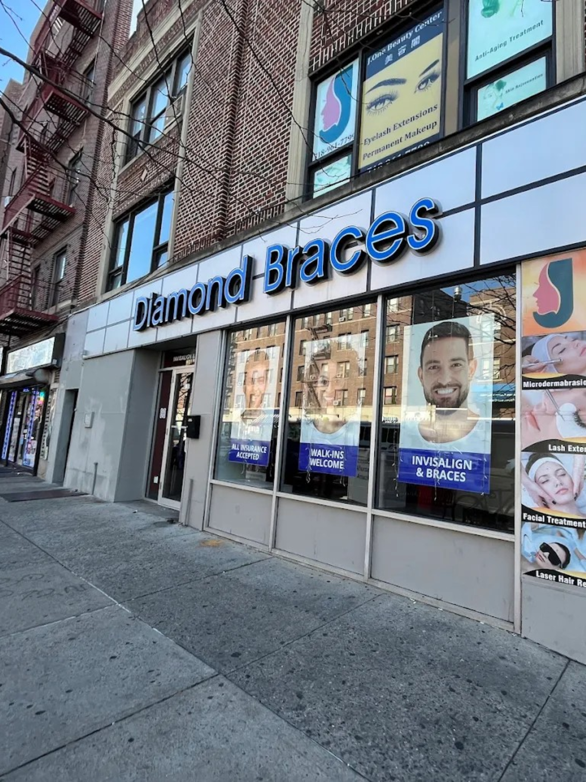Diamond Braces local dentist clinic store front with promotional posters on a new york city street.