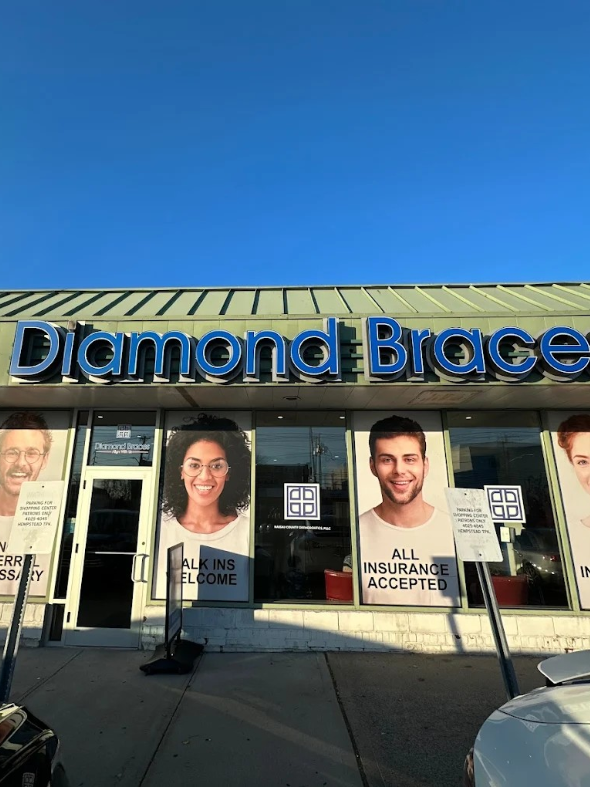 Diamond Braces dental clinic entrance with large blue signage and promotional posters on windows.