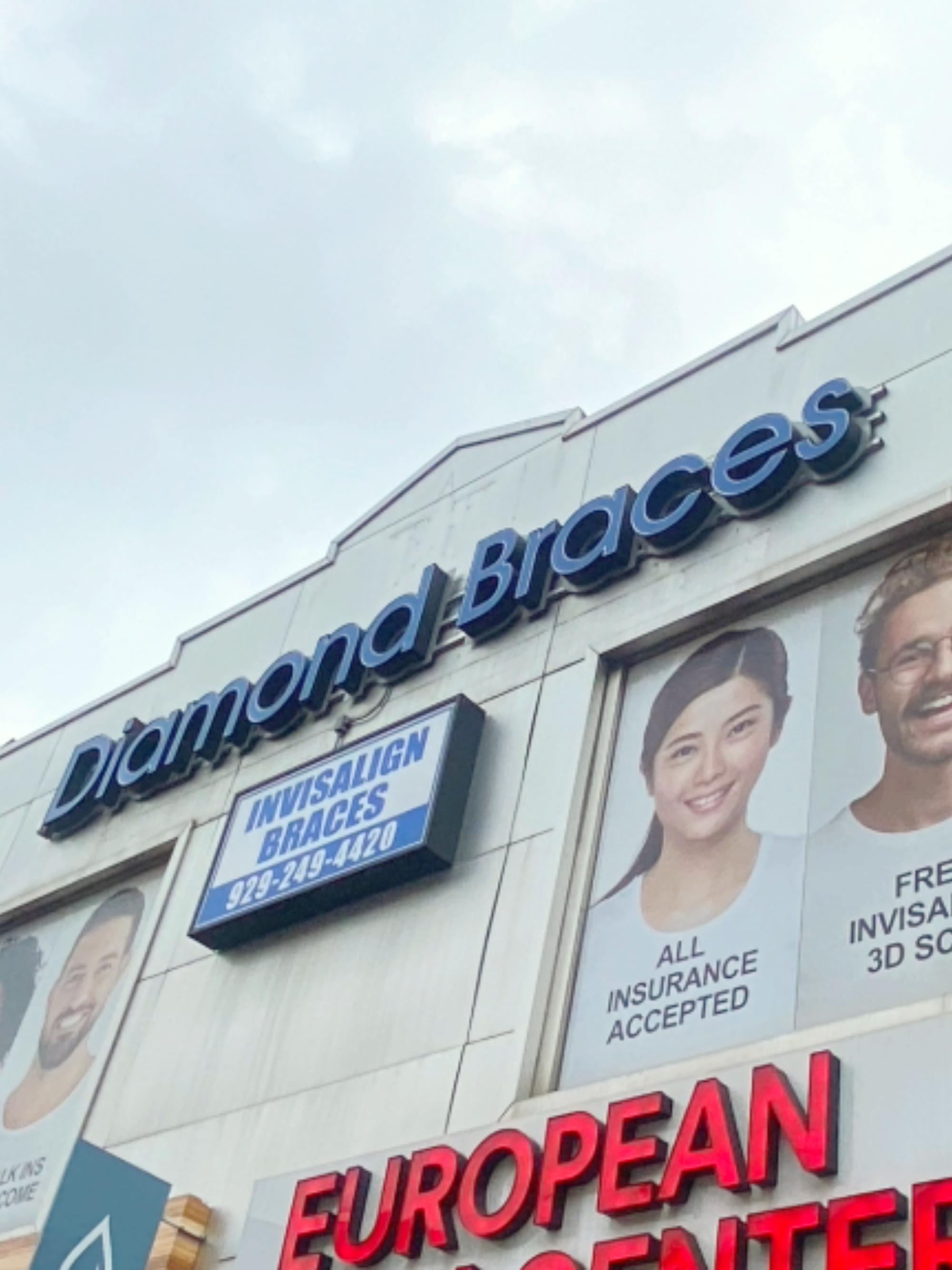 Diamond Braces dental clinic exterior with promotional signs and images of people with ceramic and clear braces.