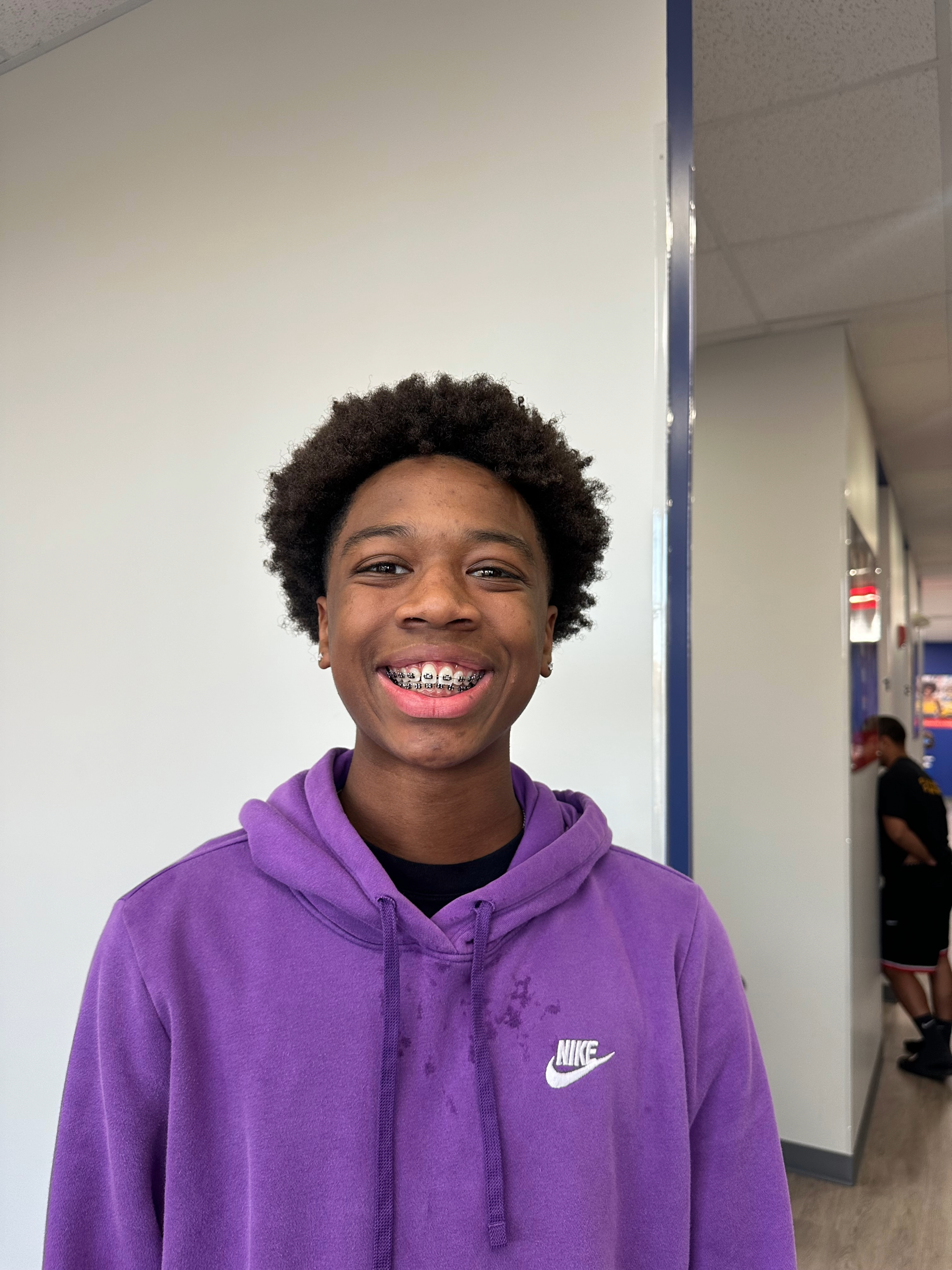 Dental care patient wearing a purple Nike hoodie in a Diamond Braces orthodontist office.