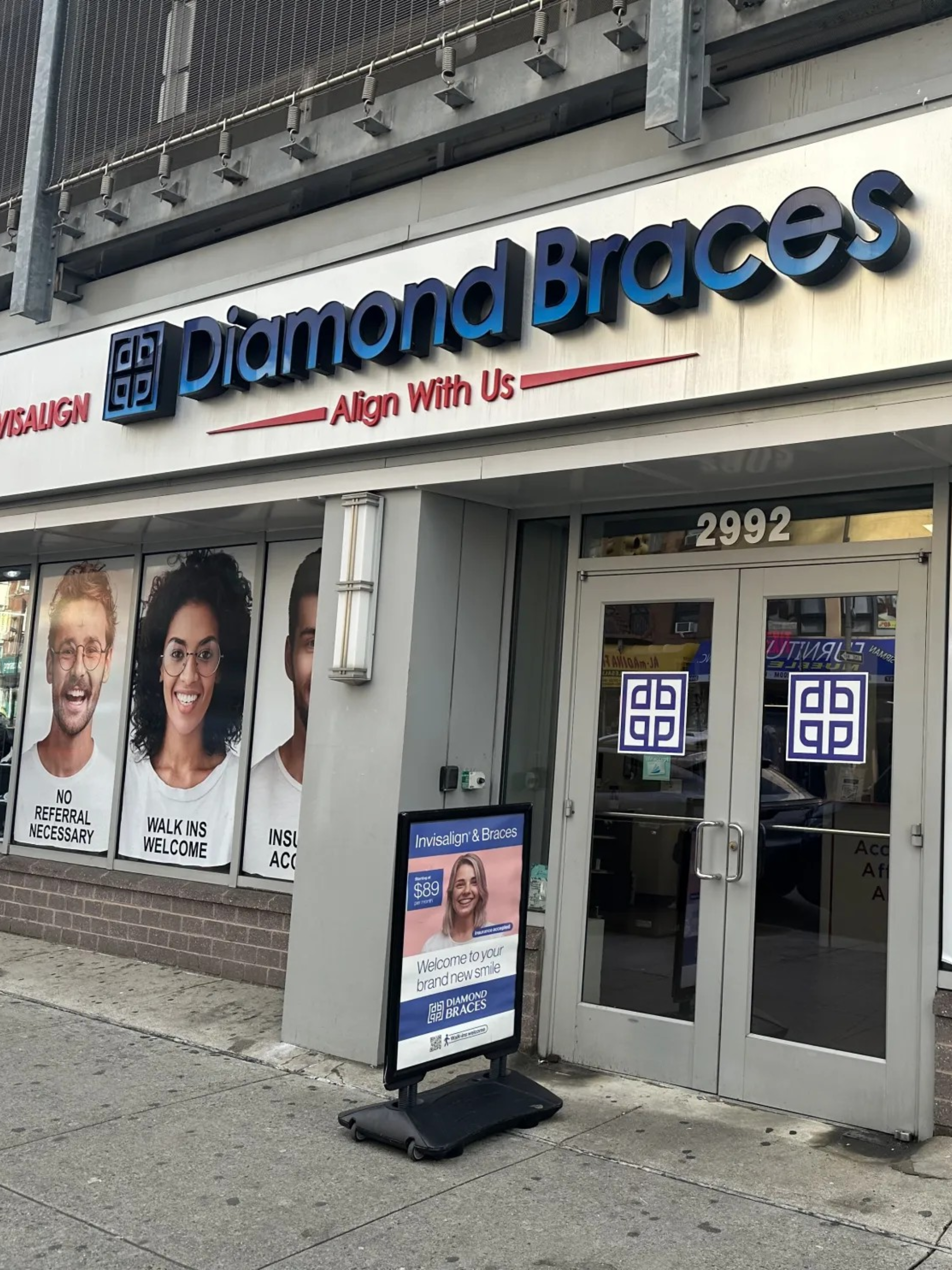 Diamond Braces dental office exterior with branding and promotional materials for Invisalign and lingual braces.