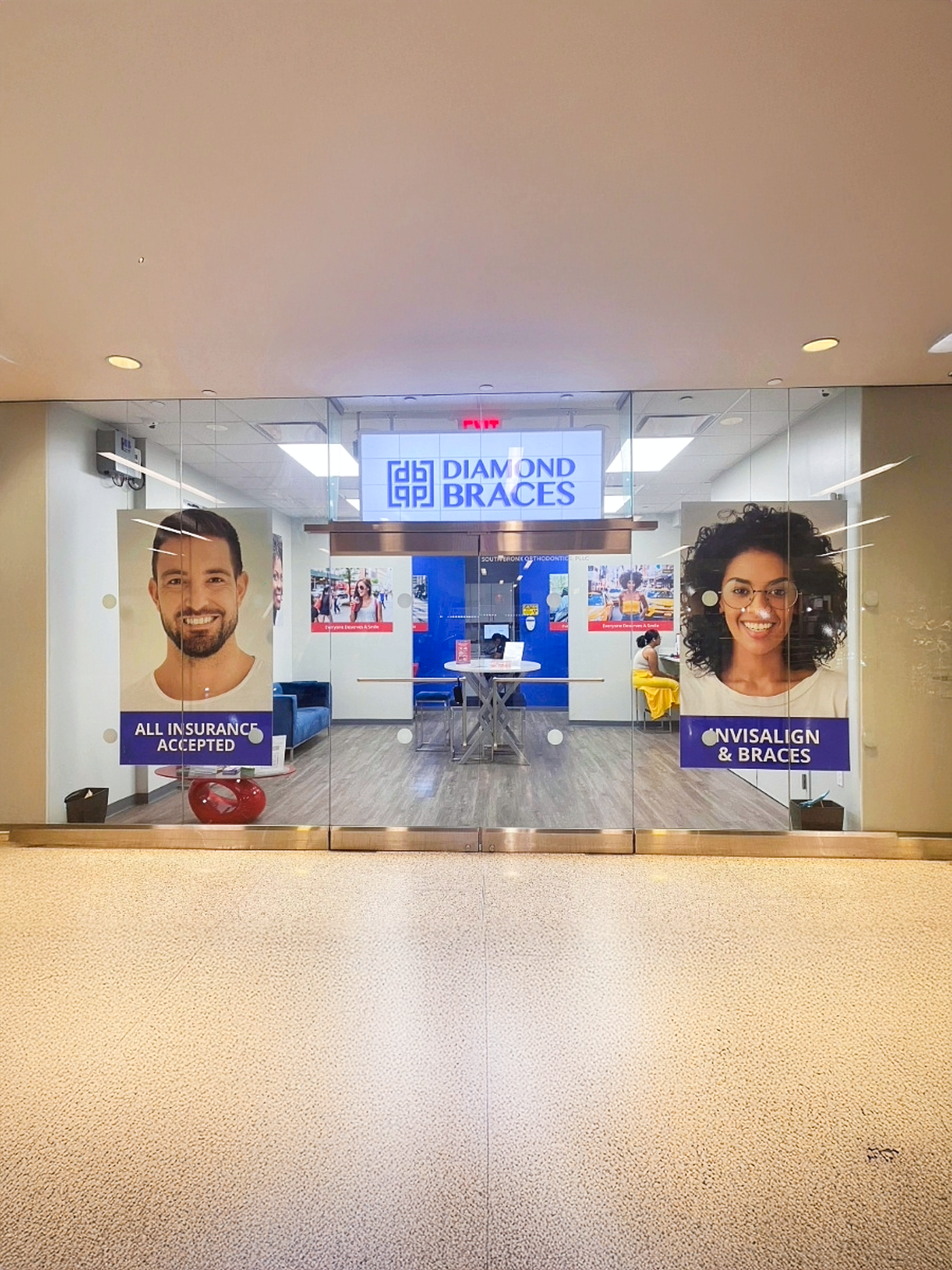 Diamond Braces dental office with reception desk and promotional posters on glass wall for Invisalign.