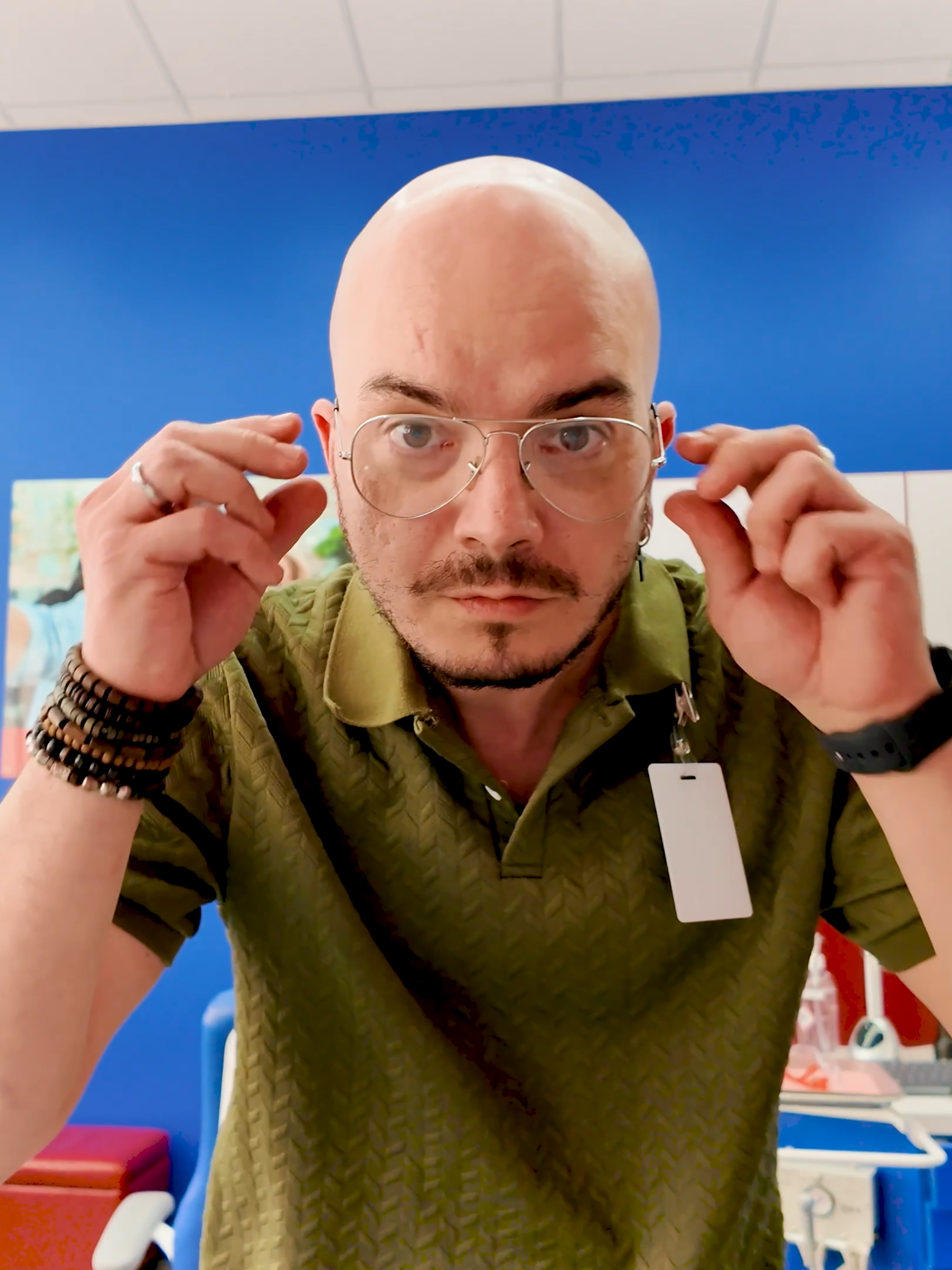 Dental clinic manager wearing glasses and a green shirt inside of a Diamond Braces orthodontist office.