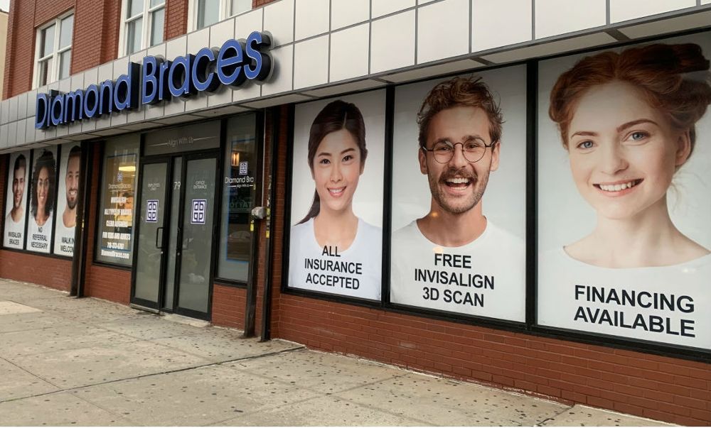 Diamond Braces dental care clinic exterior with promotional posters on a building facade in the Bronx.