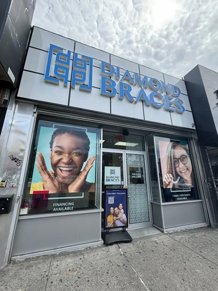 Diamond Braces dental office exterior with promotional posters of Invisiline and metal braces on a cloudy day.