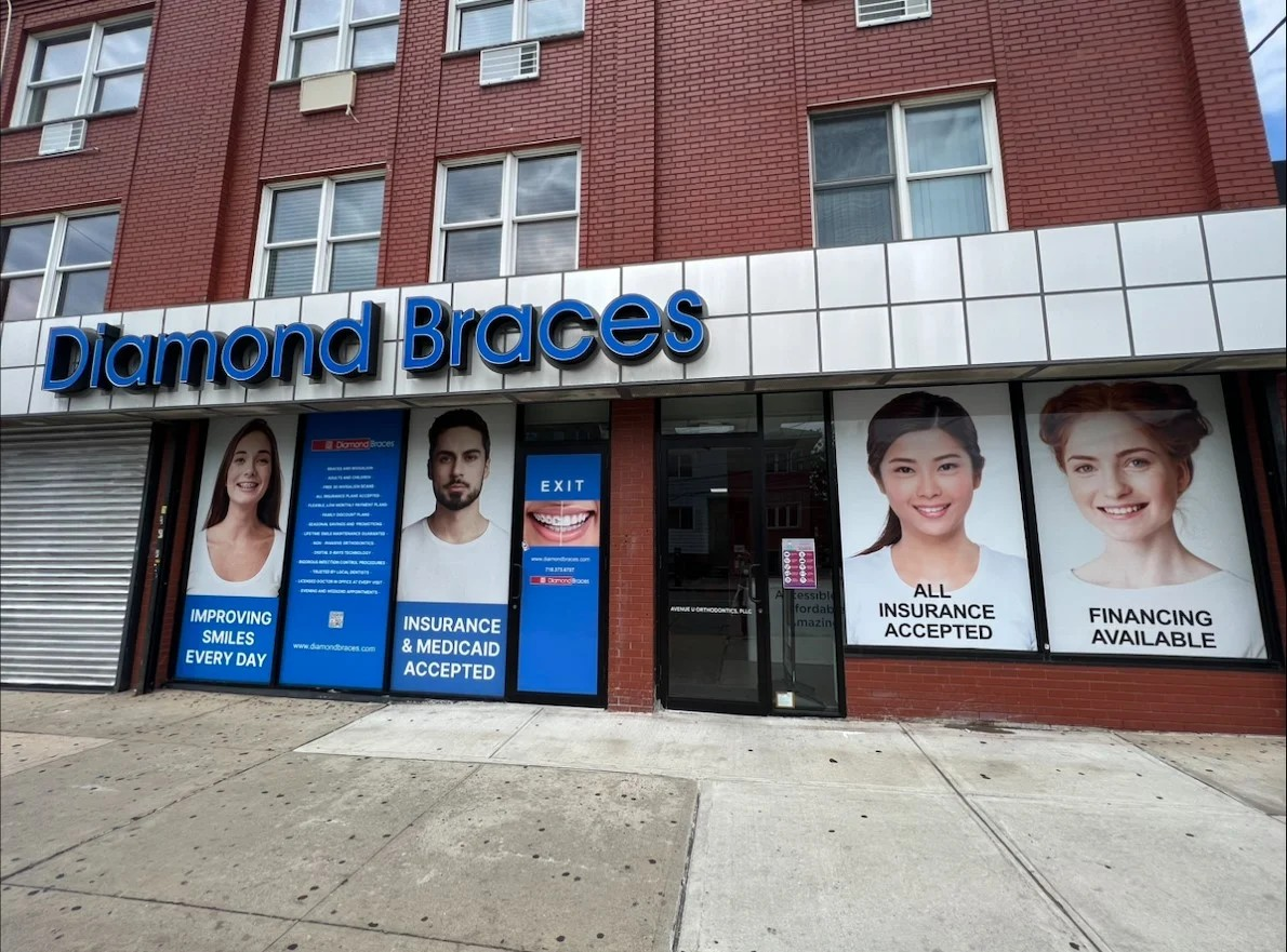 Diamond Braces dental clinic exterior with promotional posters on a brick building in Fair Lawn, New Jersey.