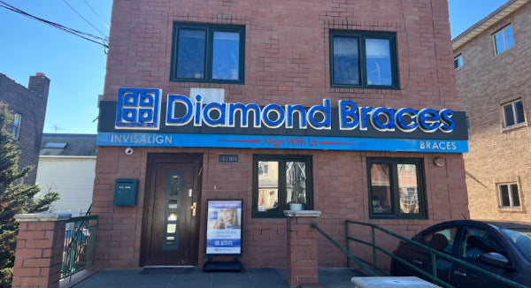 Brick building dental clinic with Diamond Braces signage on a clear day.
