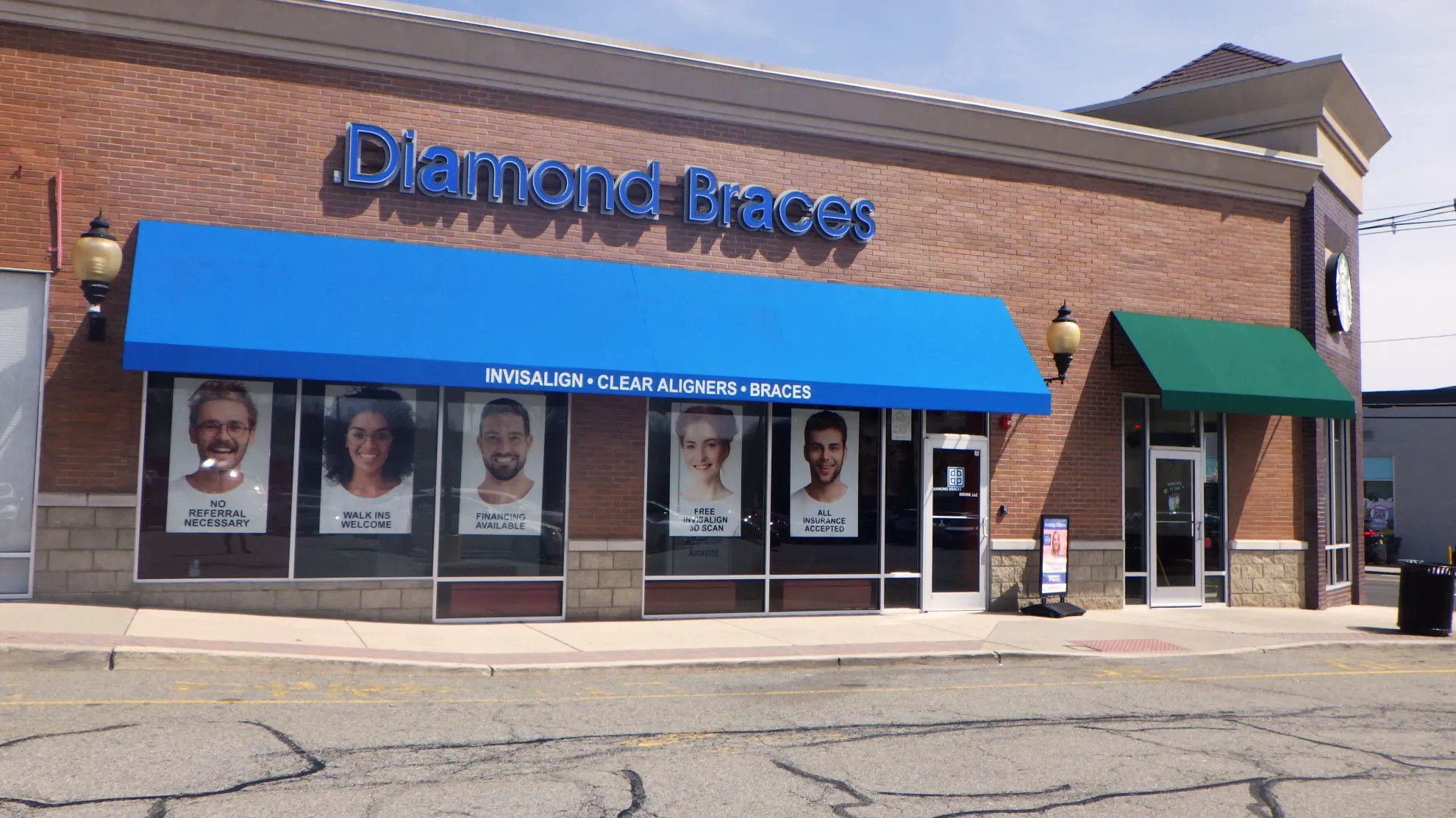 Diamond Braces dental care clinic entrance with a blue awning and promotional posters on the windows in Denville, New Jersey.