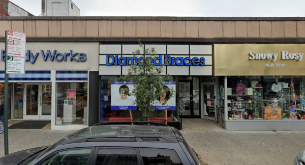 Commercial building in Forest Hills with various shops including 'Bicycle Works' and a Diamond Braces dental clinic.