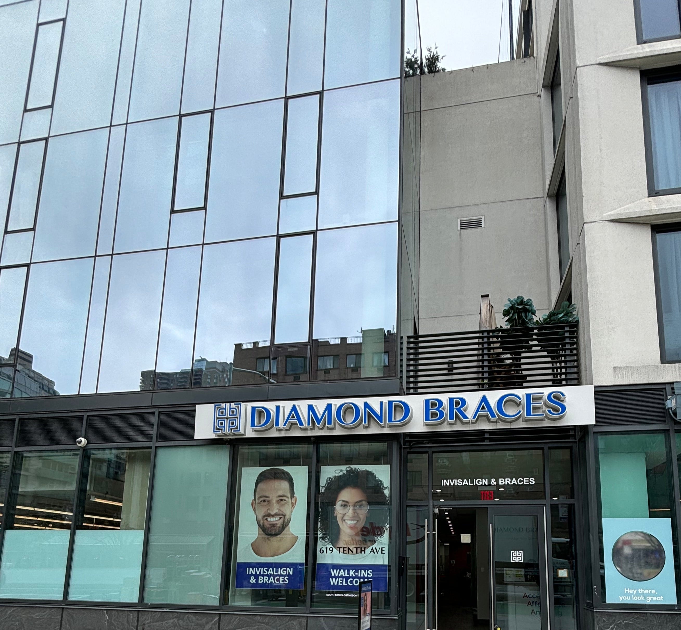 Diamond Braces dental clinic exterior with glass facade and promotional posters.