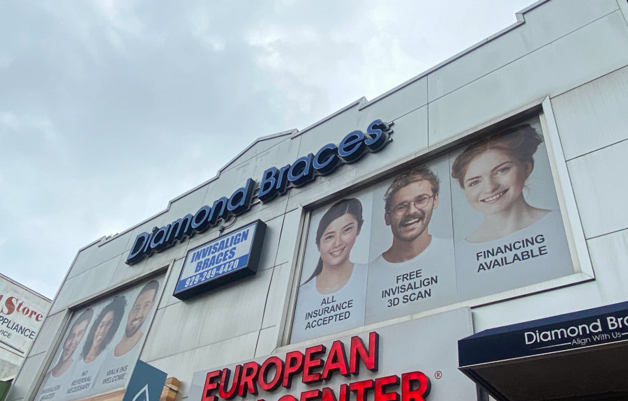 Diamond Braces dental care office exterior with promotional signs and images of people in Queens.