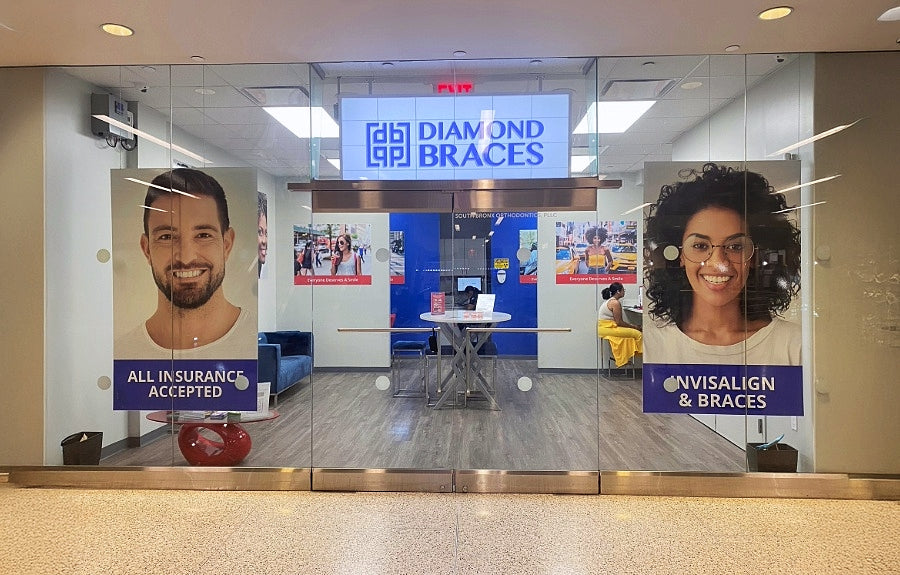 Diamond Braces orthodontics office with promotional posters on glass walls in Manhattan.