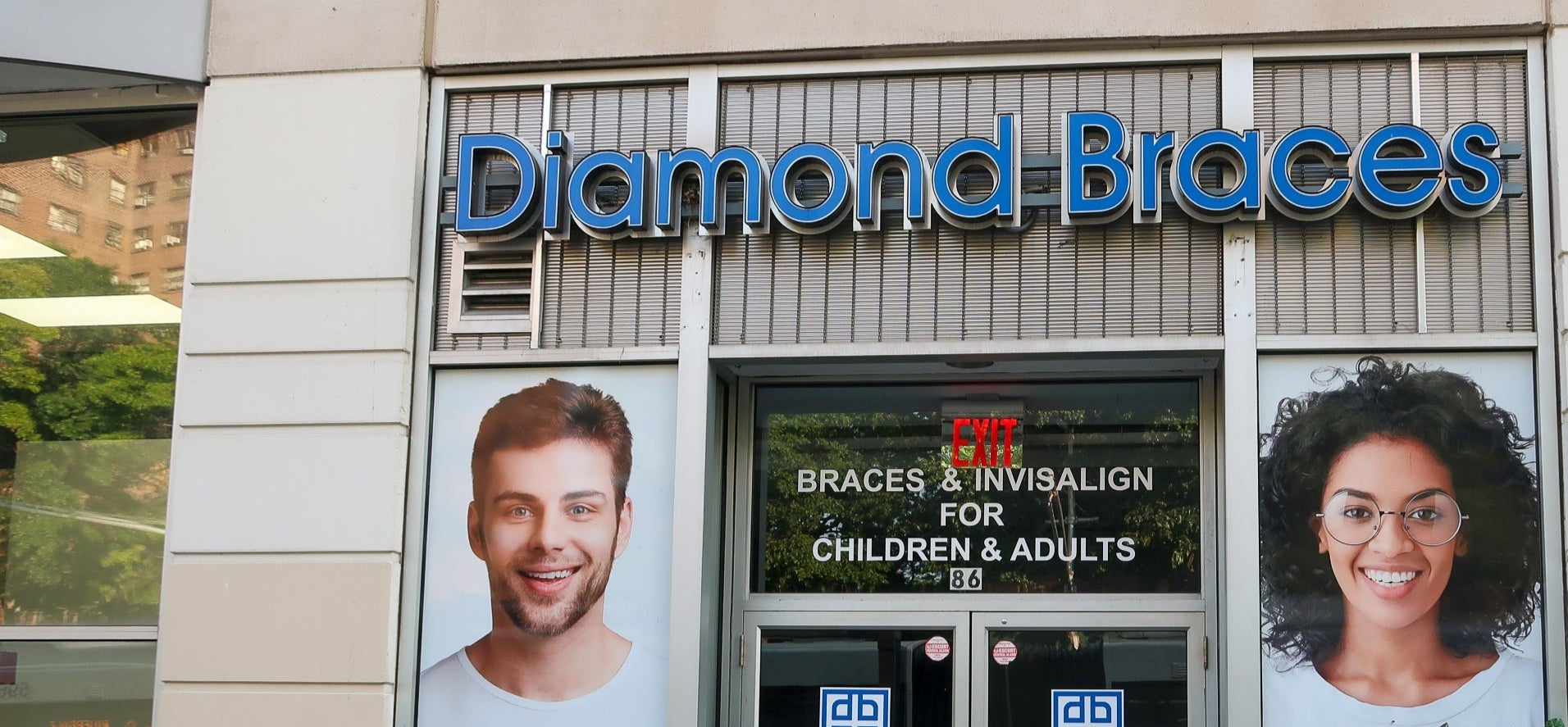 Diamond Braces dental care office with promotional images of a man and woman on the glass doors in Bronx.