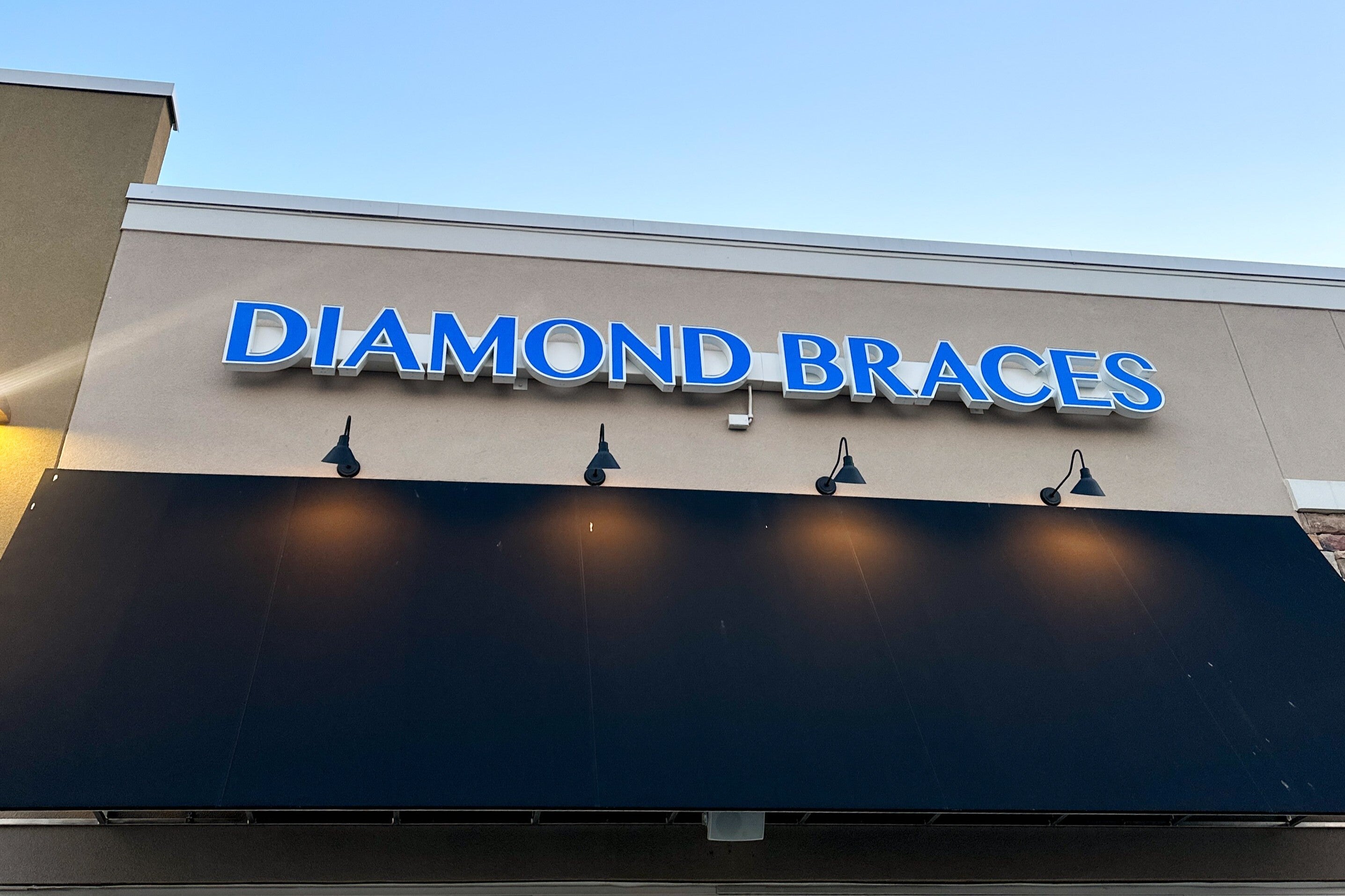 Low angle shot of the new Old Bridge, New Jersey dental clinic with a sign that says Diamond Braces.