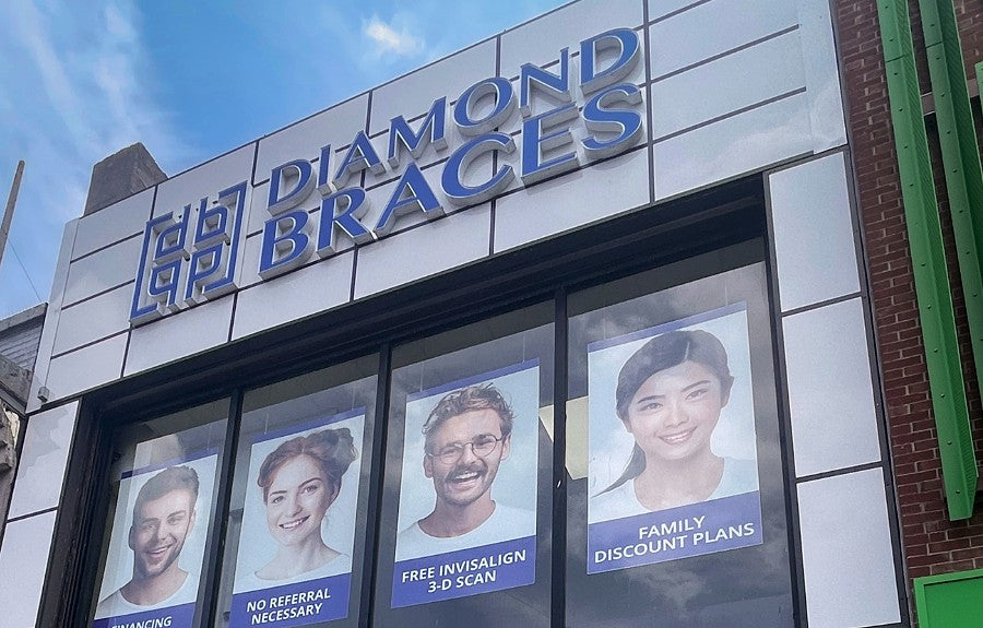 Diamond Braces dentist office exterior with promotional posters on the window.