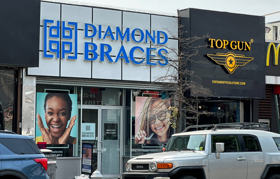Diamond Braces dental clinic with Top Gun and McDonald's signs in the background in the Bronx.