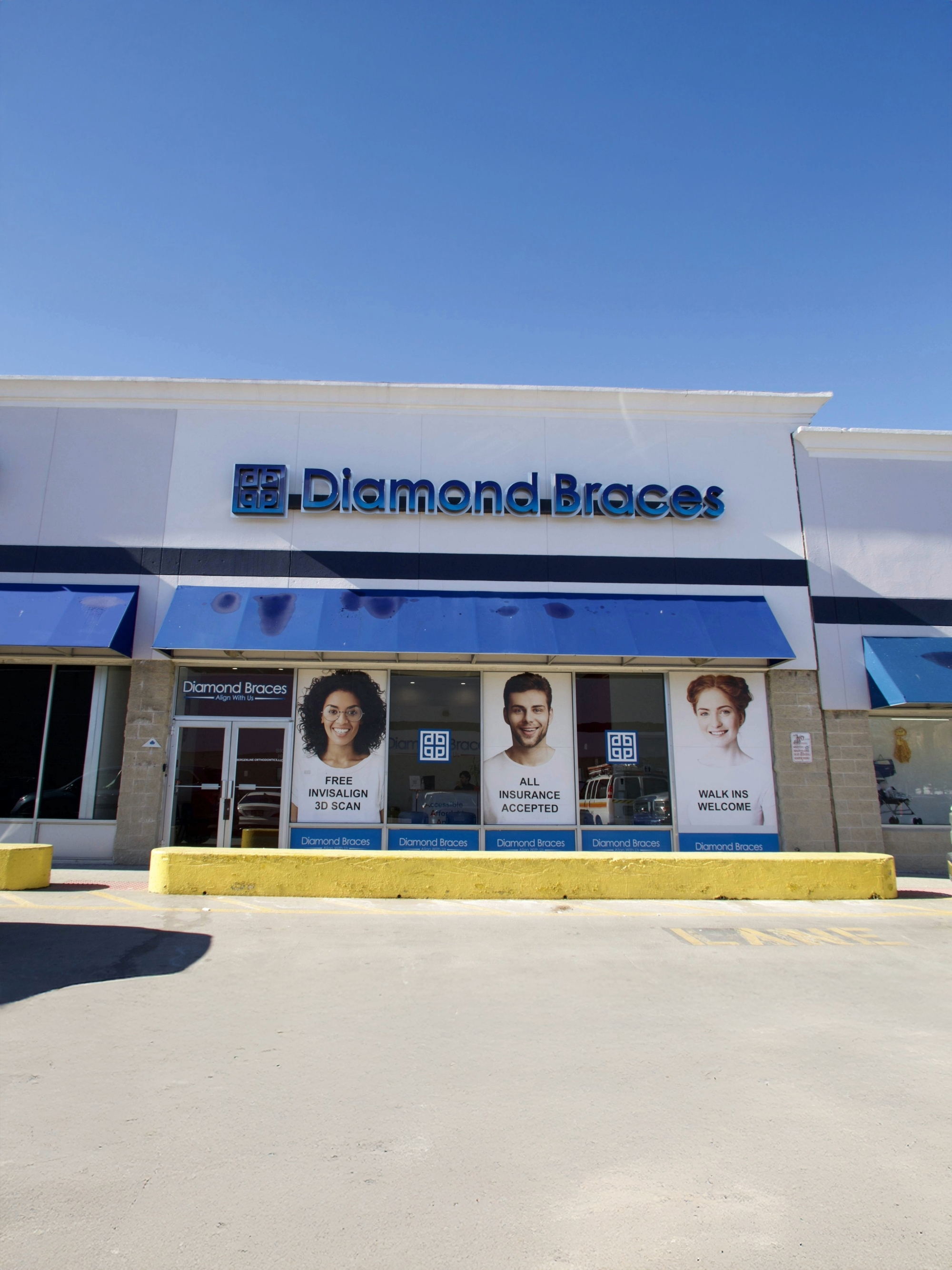 Diamond Braces dental office building with blue awnings and promotional posters for FREE Invisalign scan.
