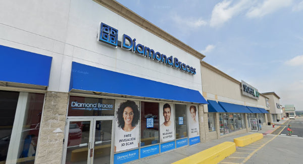 Diamond Braces dental care clinic store front with blue awning and signage in a North Bergen strip mall.