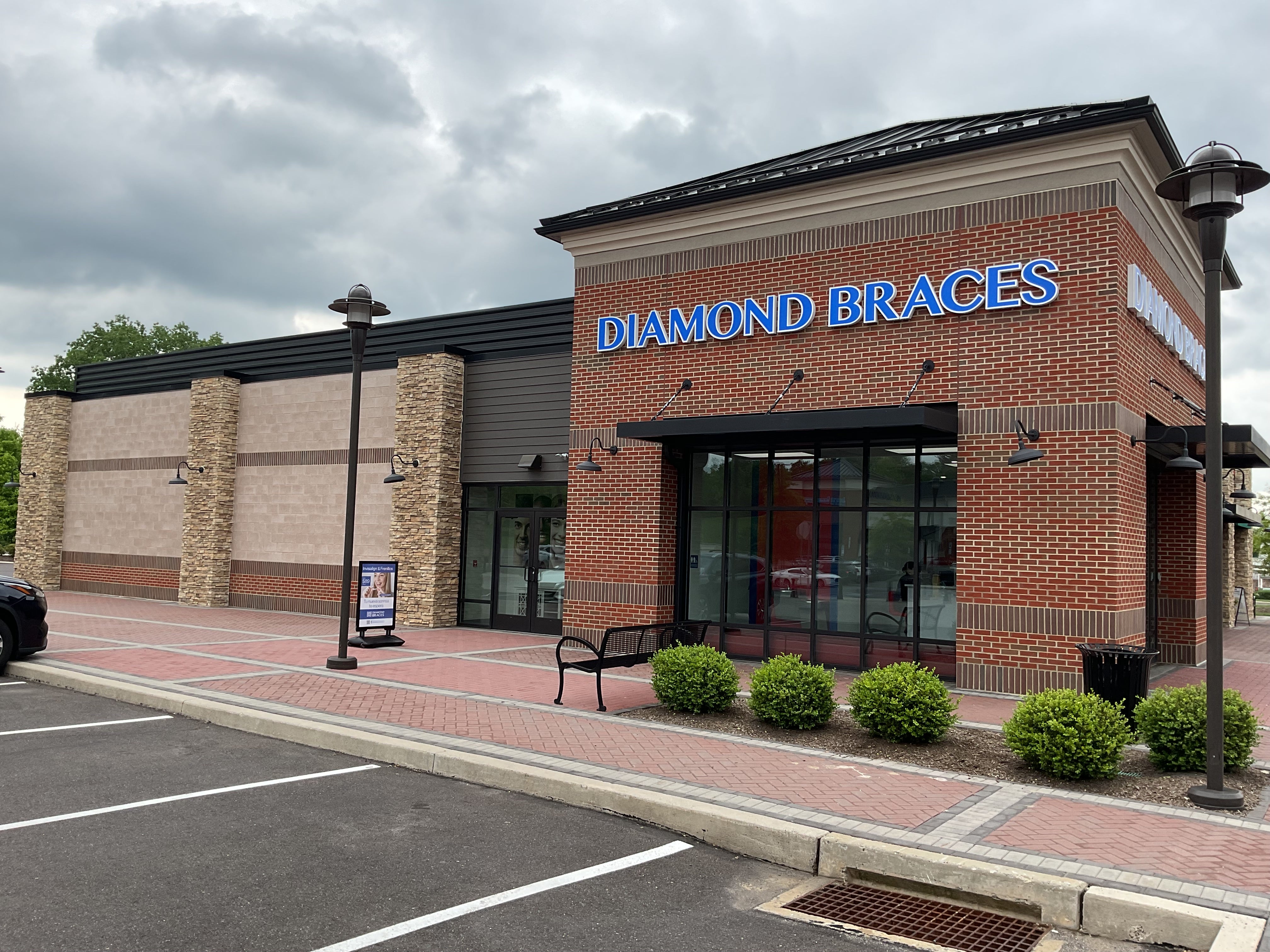 Diamond Braces orthodontist office building with a parking lot and sidewalk in Blue Bell, PA.