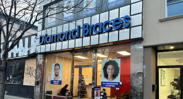 Local Diamond Braces dentist office with large blue sign and glass windows in Park Slope.