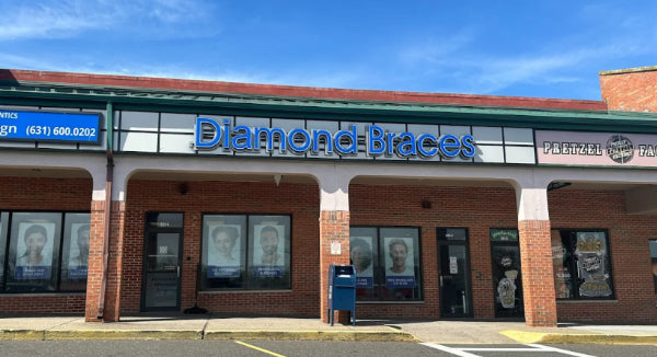 Diamond Braces dental care office building with blue sign and brick facade in Long Island.