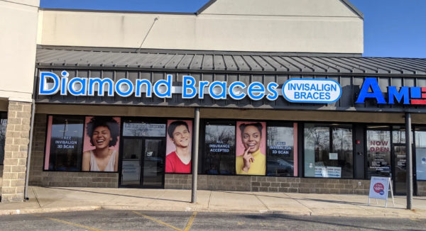 Diamond Braces orthodontist clinic store front with promotional posters on a clear day in Spring Valley.