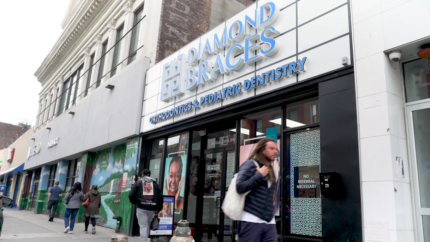 Diamond Braces dental clinic exterior with people walking by in Manhattan.