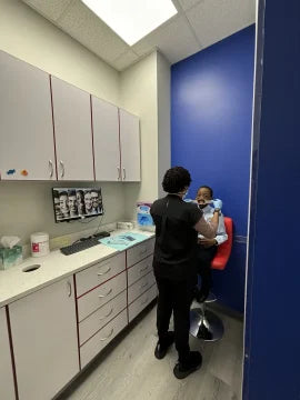 Image of an orthodontic assistant prepping her patient to be seen by dentist.