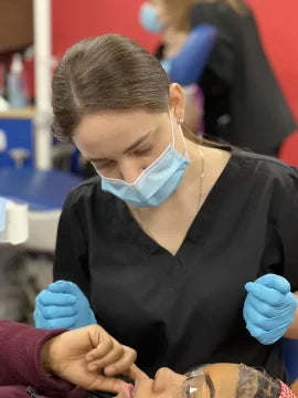 Image of a dental assistant in a New York dental clinic over seeing her patient.
