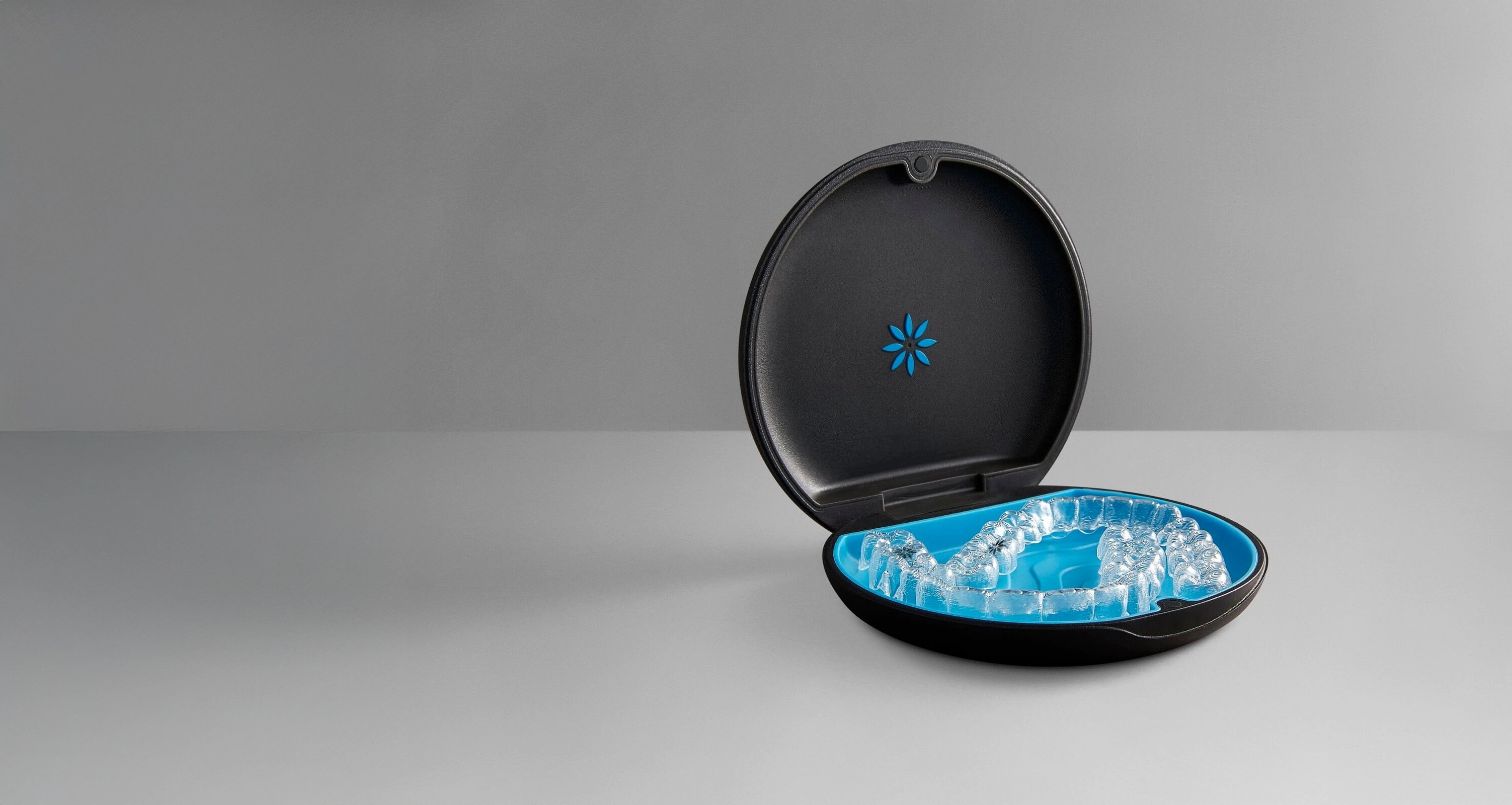 Image of an Invisalign clear aligner in a black and blue case.